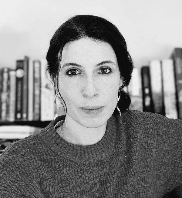 Ira Ribbon in front of a bookshelf